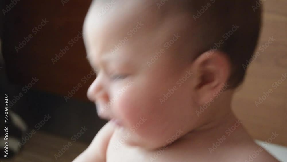 cute six months old baby boy playing with cooking pot and wooden spoon close up cute six months old baby boy playing with cooking pot and wooden spoon close up