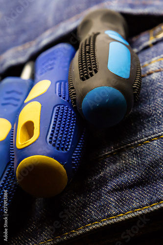 two screwdrivers lie in the breast pocket of a worker's overalls repair electrical engineering © Kai Beercrafter