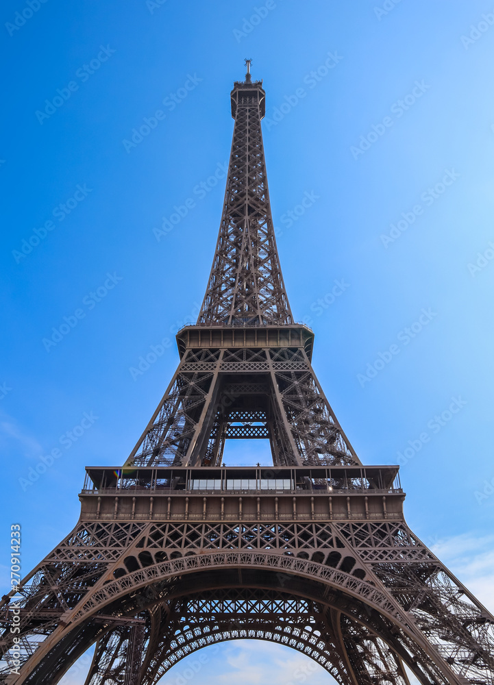 Eiffel Tower in Paris France against blue sky. April 2019