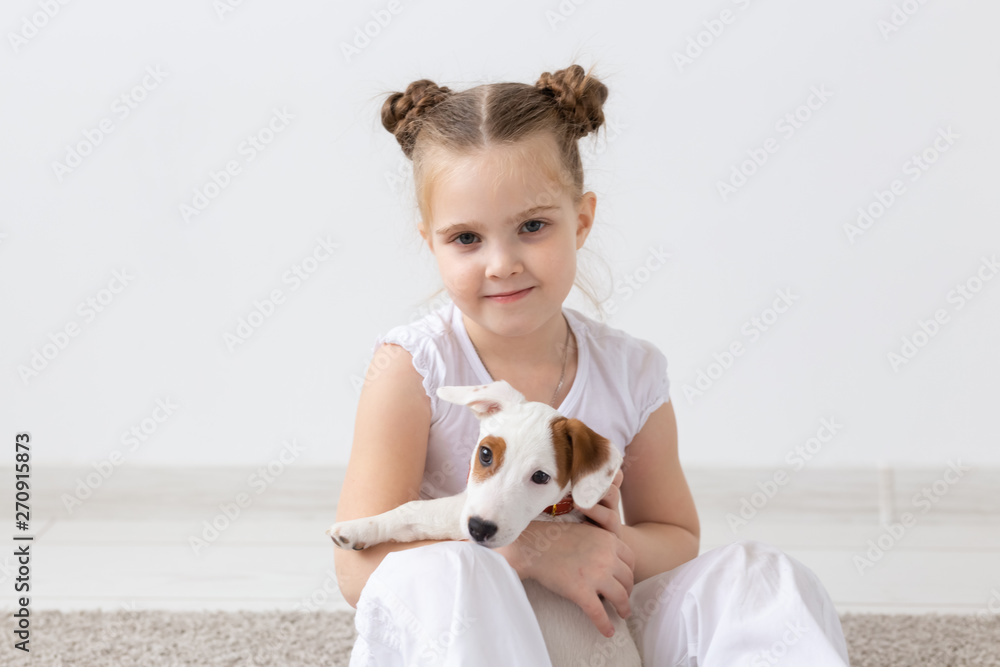 Pets and animal concept - Child girl playing with puppy Jack Russell Terrier Pets and animal concept - Child girl playing with puppy Jack Russell Terrier