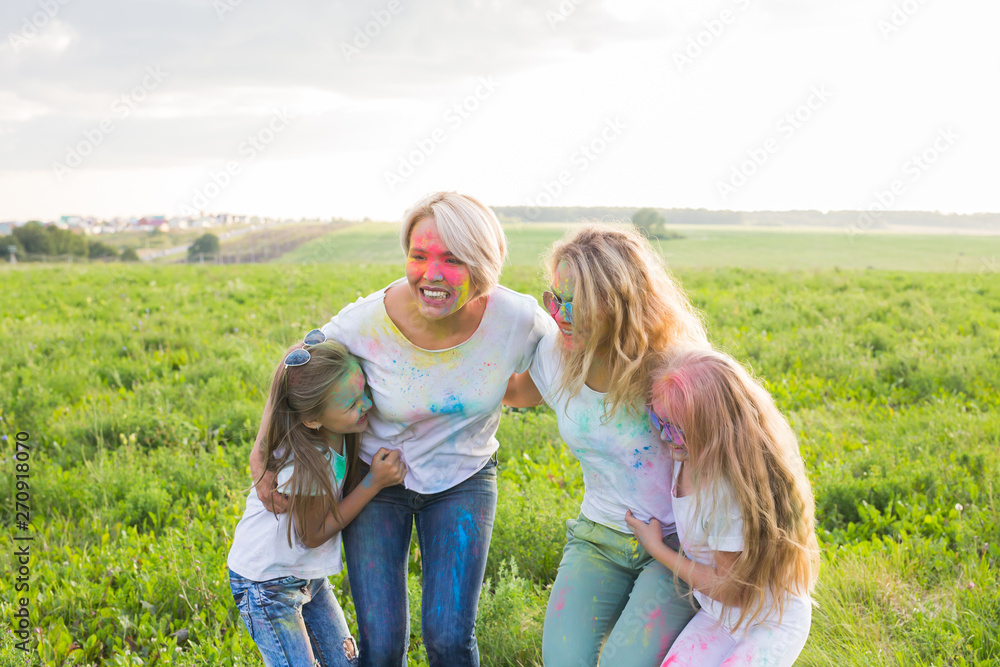Friendship, Indian holidays and people concept - young women and children dancing on the summer field on festival of holi Friendship, Indian holidays and people concept - young women and children dancing on the summer field on festival of holi