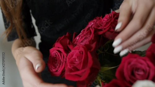 Woman Holds a Bouquet of Red Roses