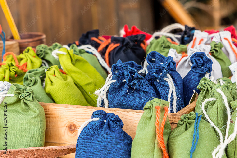 jute pouch of grass sachets natural eco materials. Blue small blue green bags close-up