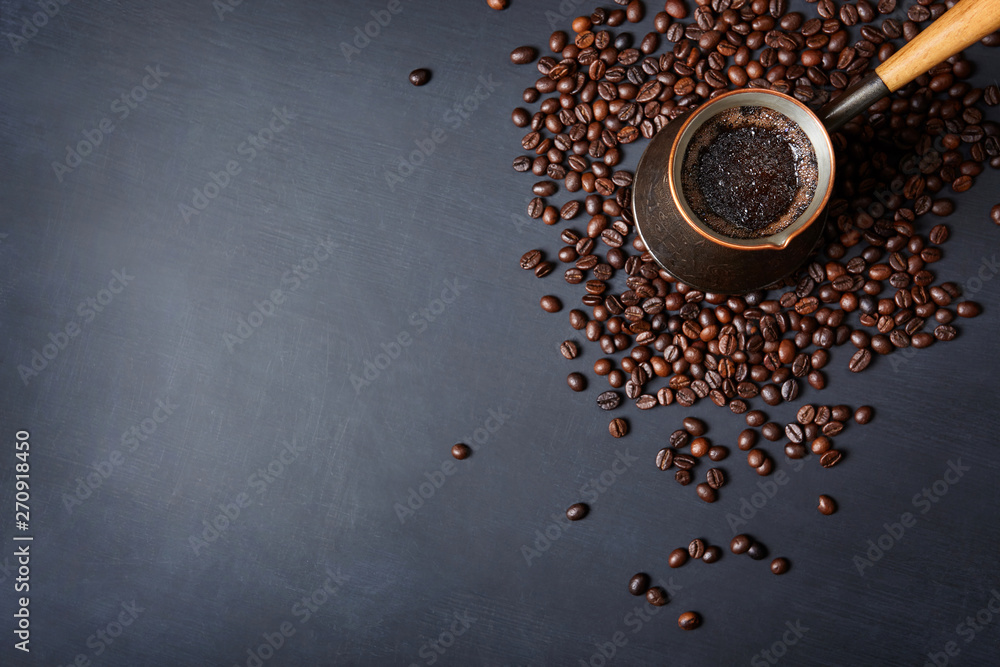 Turkish coffee pot and coffee beans on black background with copy space. Turkish coffee pot and coffee beans on black background with copy space.