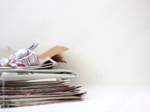 Paper waste: stack of old newspapers and pieces of cardbord and paper.