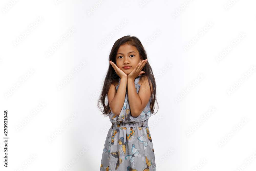 Pretty asian girl in butterflies dress joins hands under the face Pretty asian girl in butterflies dress joins hands under the face