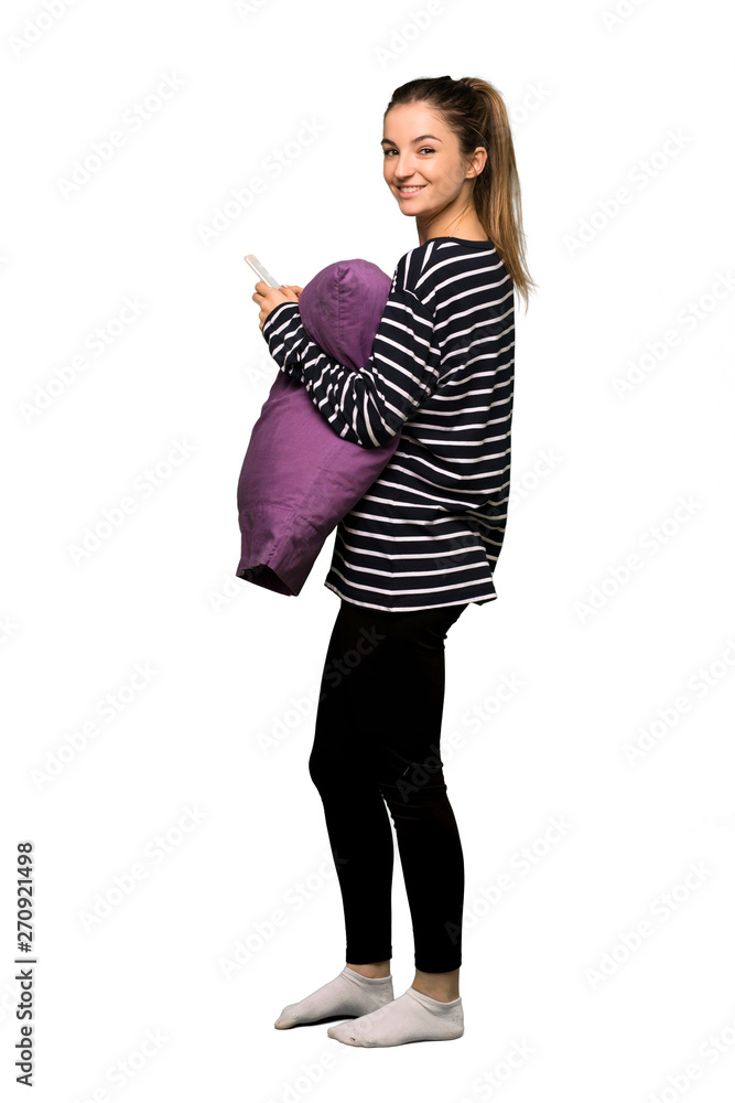Full body Pretty woman in pajamas sending a message with the mobile on isolated background Full body Pretty woman in pajamas sending a message with the mobile on isolated background