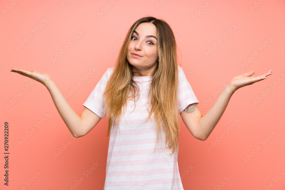 Young woman over isolated pink wall having doubts with confuse face expression Young woman over isolated pink wall having doubts with confuse face expression