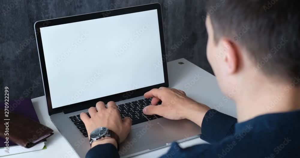 Businessman working at the computer. young man typing on laptop. Freelancer works for noutbokom.