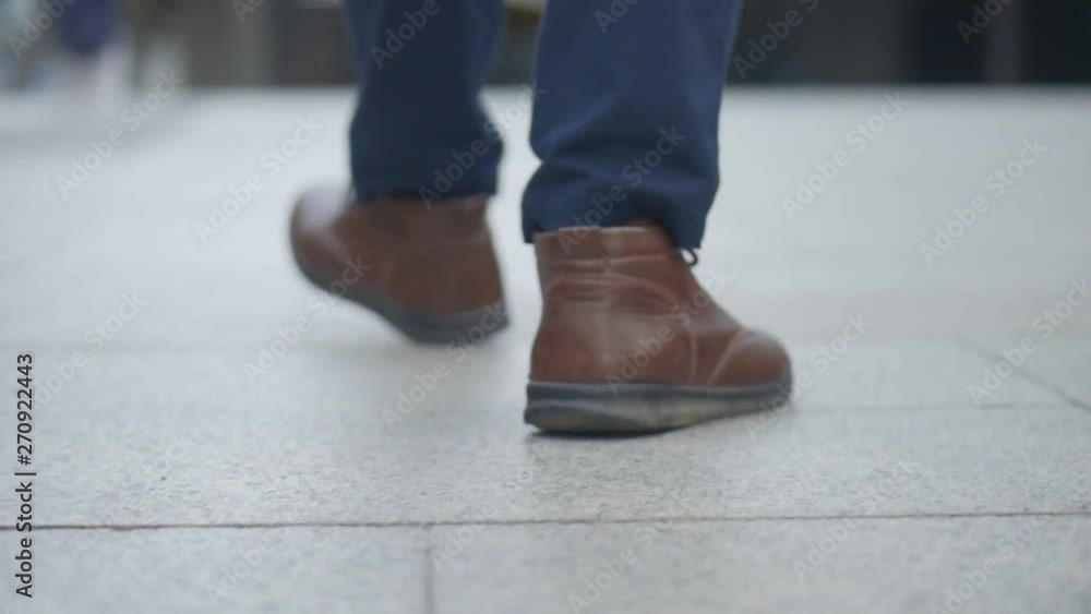 Close up of the legs asian businessman walking in the street. Close up of the legs asian businessman walking in the street.