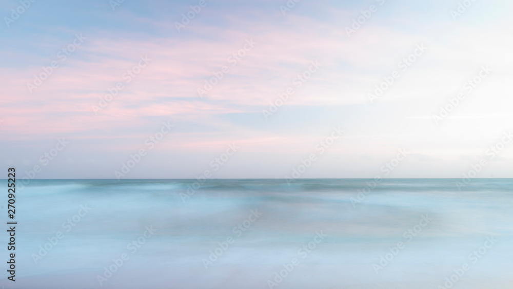 Beautiful artistic colorful landscape image of blurred waves at sunset in Devon Enlgand