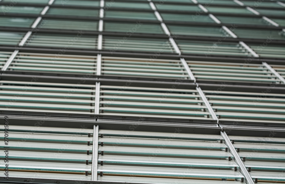 Obraz premium Background or texture from a gray and monophonic metal surface with glass sheets. Crossbeams. Construction materials.