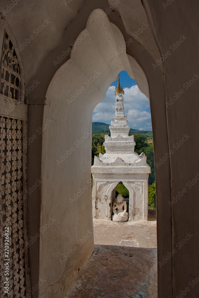 Naklejka premium Myanmar. Hsin Phyu Shin Pagoda was built in 1816 with special elegance, includes a multi-tiered gallery with small pagoda towers and symbolizes the cosmogonic structure of the universe