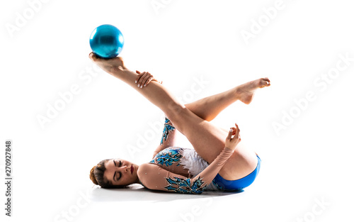 Girl doing rhythmic gymnastics with ball .