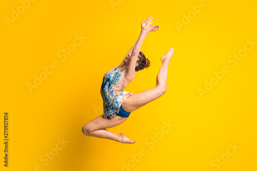 Girl doing rhythmic gymnastics jumping