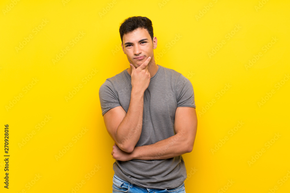 Handsome man over isolated yellow wall thinking Handsome man over isolated yellow wall thinking