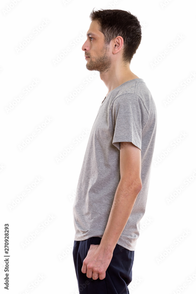 Profile view portrait of young man standing Profile view portrait of young man standing