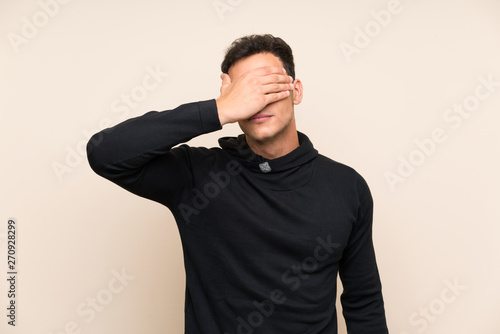 Handsome man over isolated background covering eyes by hands © luismolinero