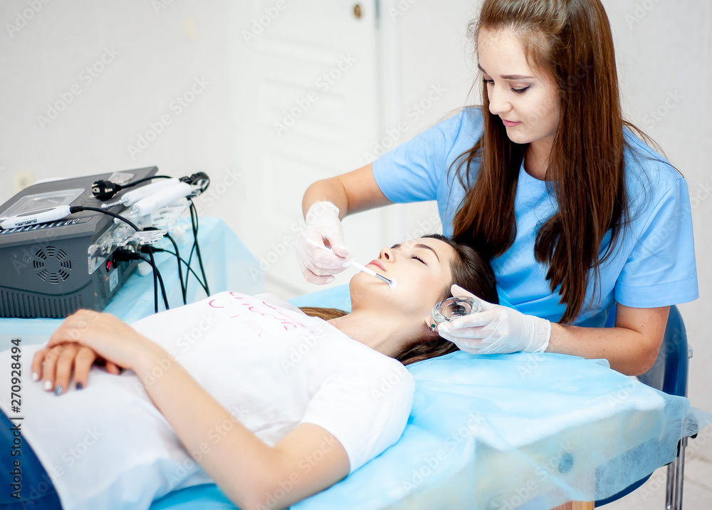 Cosmetic procedure for the face. The procedure of applying the medicine on the face of a beautiful woman. comet clinic Cosmetic procedure for the face. The procedure of applying the medicine on the face of a beautiful woman. comet clinic