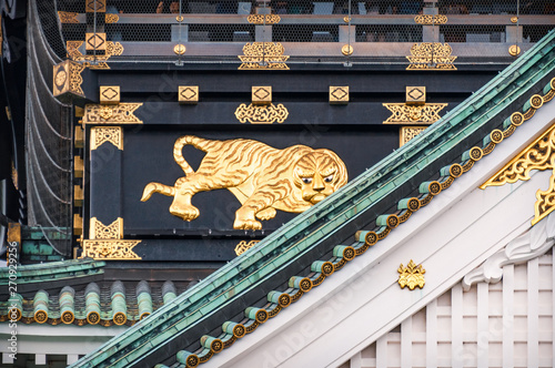 The main tower of Osaka Castle's exterior is covered in gold leaf ornaments designed to impress and demoralize enemies. It features eight giant golden tiger 'fusetora' and golden sachi roof ornaments. photo