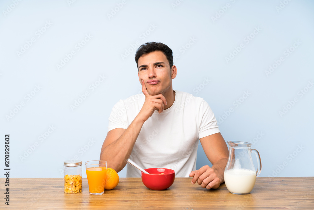 Handsome man in having breakfast thinking an idea Handsome man in having breakfast thinking an idea
