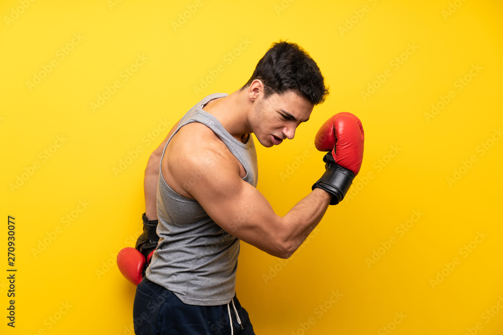 Handsome sport man over isolated background with boxing gloves