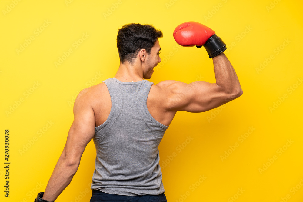 Handsome sport man over isolated background with boxing gloves Handsome sport man over isolated background with boxing gloves