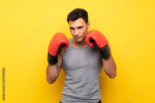 Handsome sport man over isolated background with boxing gloves © luismolinero