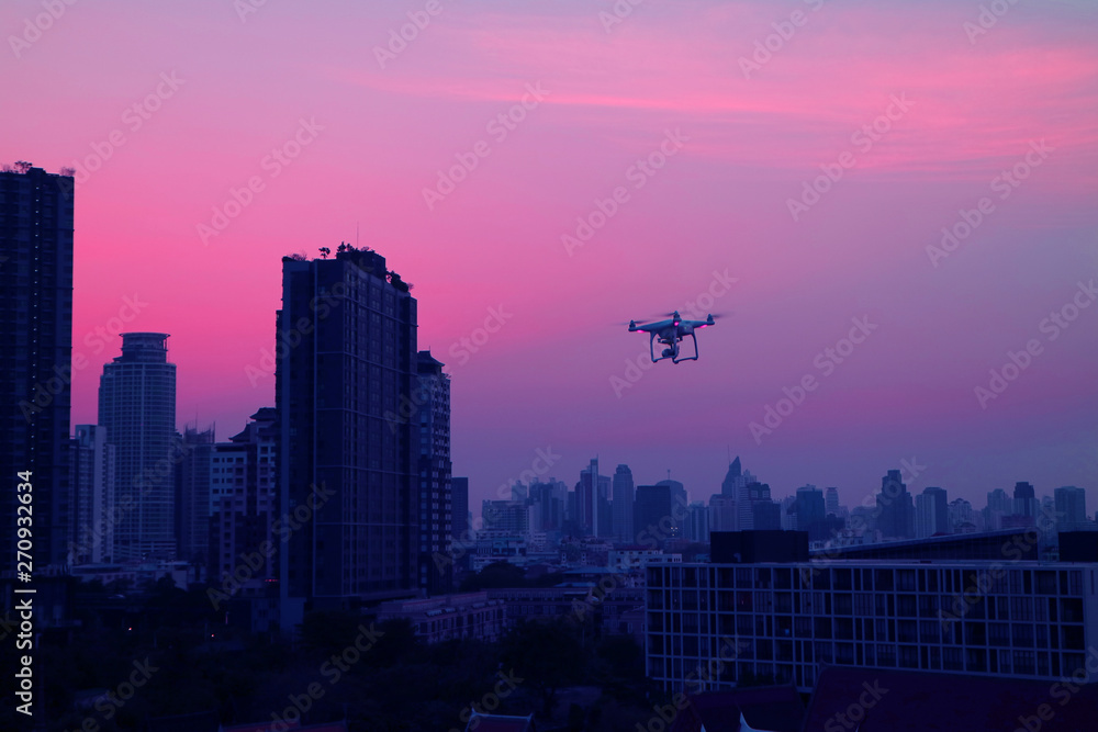 Drone flying in Evening Sky over the Skyscrapers of Bangkok's Suburban, Thailand