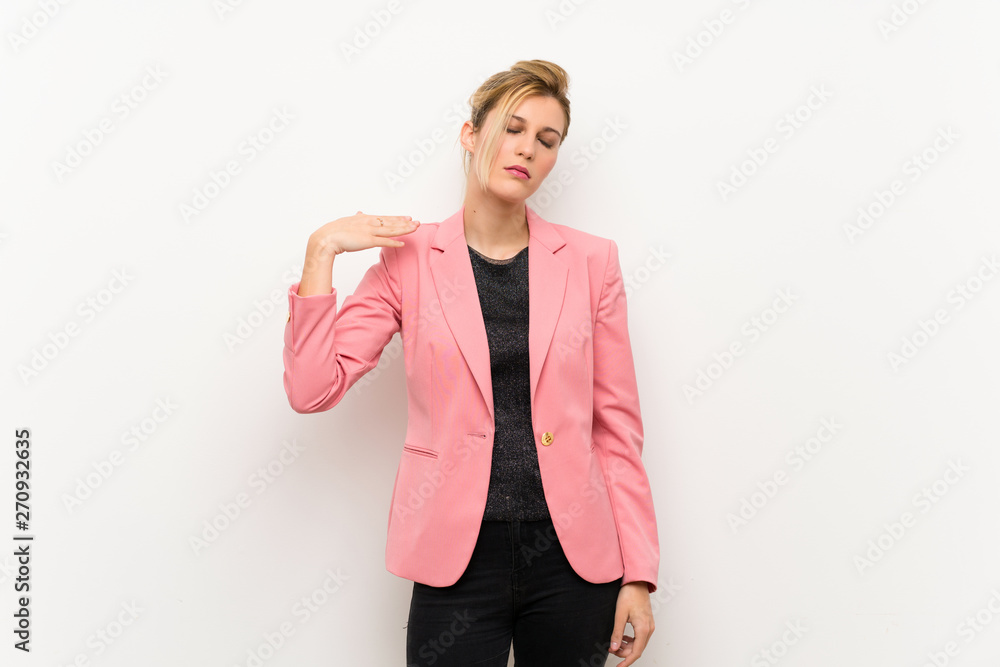 Young blonde woman with pink suit with tired and sick expression Young blonde woman with pink suit with tired and sick expression