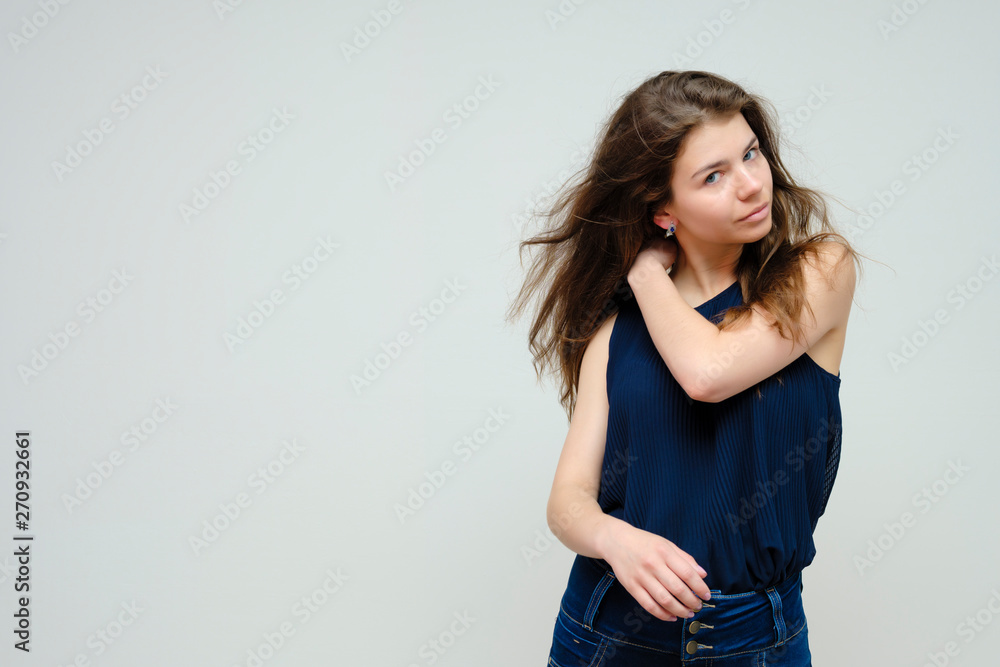 Photo portrait of a beautiful sexy brunette woman girl, smiling and pleased with life, with long flowing dark hair on a white background. Photo portrait of a beautiful sexy brunette woman girl, smiling and pleased with life, with long flowing dark hair on a white background.