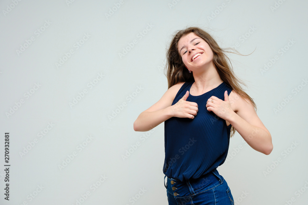 Photo portrait of a beautiful sexy brunette woman girl, smiling and pleased with life, with long flowing dark hair on a white background. Photo portrait of a beautiful sexy brunette woman girl, smiling and pleased with life, with long flowing dark hair on a white background.