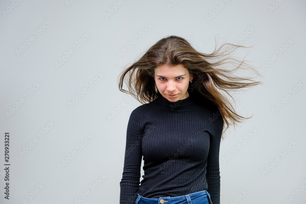 Photo portrait of a beautiful sexy brunette woman girl, smiling and pleased with life, with long flowing dark hair on a white background. Photo portrait of a beautiful sexy brunette woman girl, smiling and pleased with life, with long flowing dark hair on a white background.