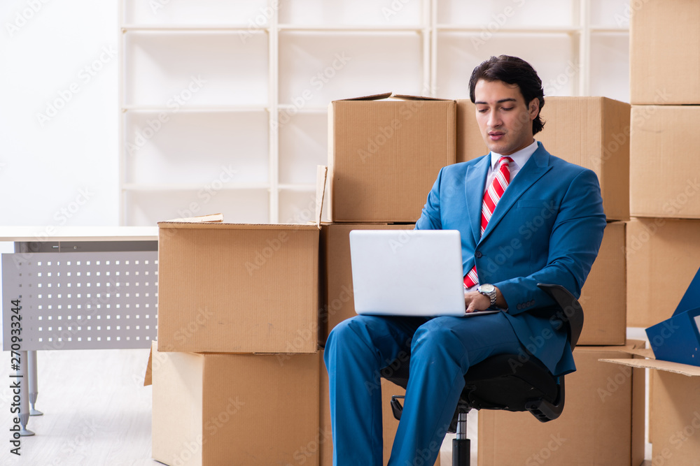 Young handsome businessman moving to new workplace Young handsome businessman moving to new workplace