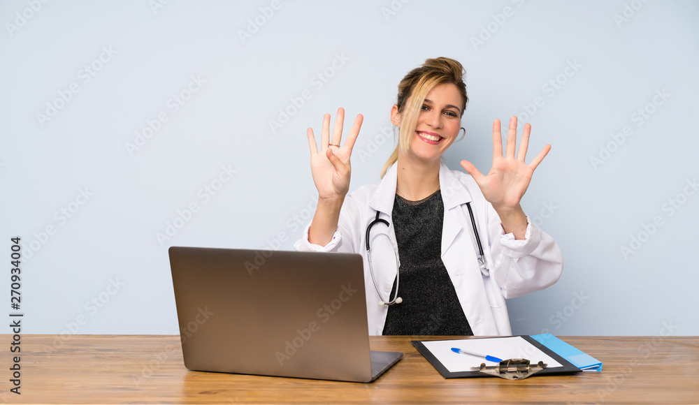 Blonde doctor woman counting nine with fingers Blonde doctor woman counting nine with fingers