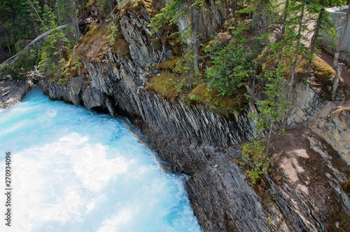Mountain turquoise river flows along the picturesque rocky shores  Kicking Horse river  British Columbia  Canada