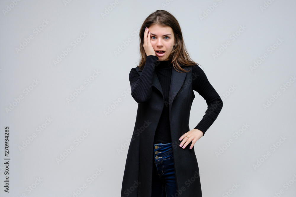 Photo portrait of a beautiful smiling brunette business woman on a white background in a black business suit with long beautiful dark hair in the studio. Photo portrait of a beautiful smiling brunette business woman on a white background in a black business suit with long beautiful dark hair in the studio.