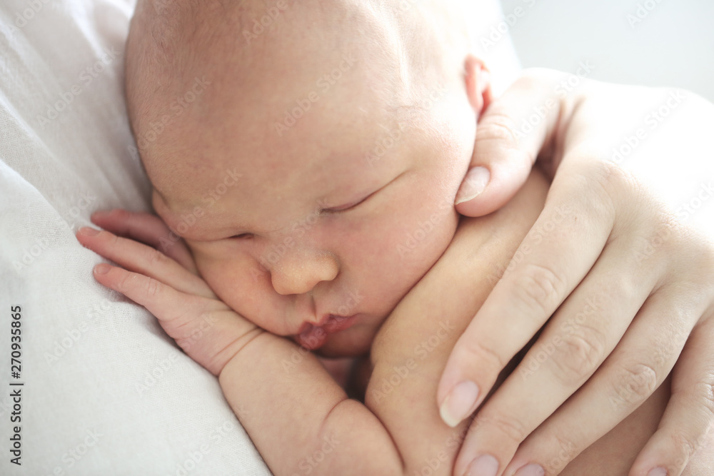 Mom and baby, newborn sleeping in mother hands