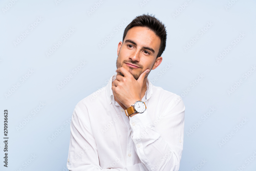 Handsome young man over isolated blue background thinking Handsome young man over isolated blue background thinking