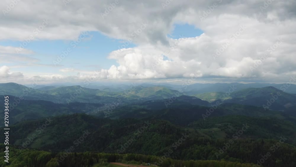 Moving forward to pine woods forest and mountain valley with sun flare in summer day. Outdoor green nature scape mountains wild aerial establisher Moving forward to pine woods forest and mountain valley with sun flare in summer day. Outdoor green nature scape mountains wild aerial establisher