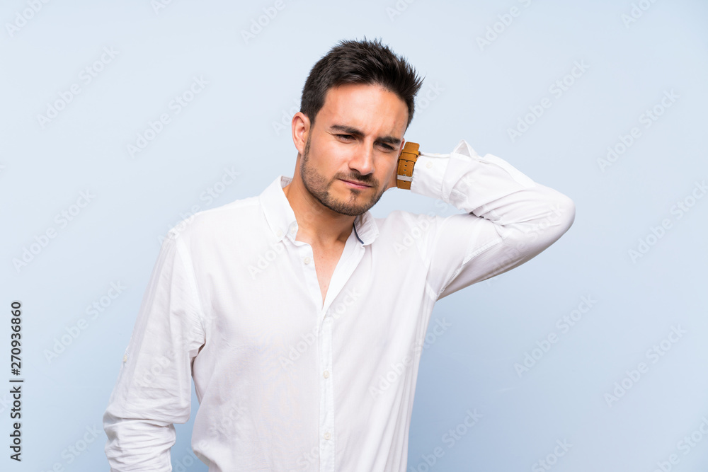 Handsome young man over isolated blue background with neckache Handsome young man over isolated blue background with neckache