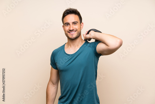 Fototapeta Naklejka Na Ścianę i Meble -  Handsome sport man over isolated background with kettlebell