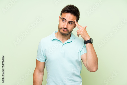 Handsome young man over isolated background with problems making suicide gesture