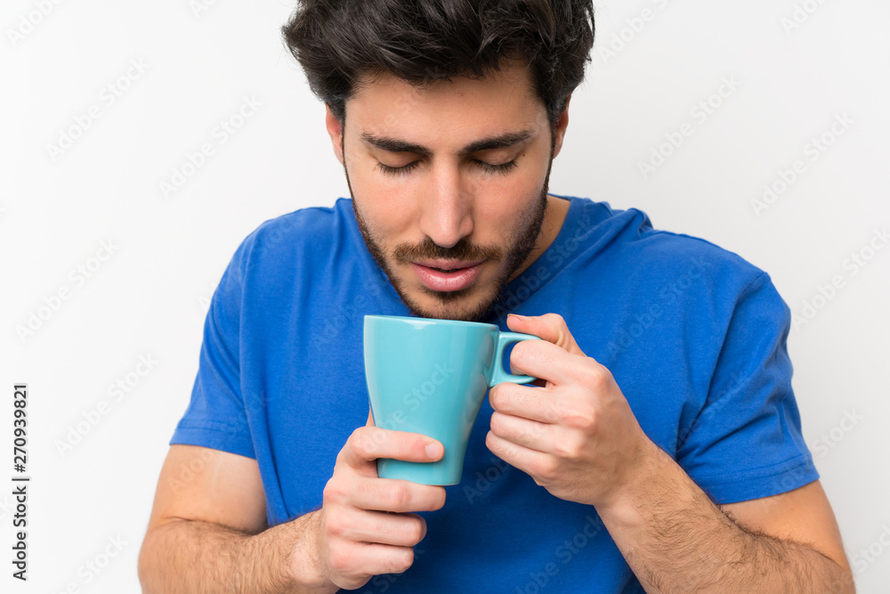 Handsome man holding hot cup of coffee Handsome man holding hot cup of coffee