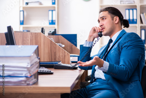 Young handsome businessman sitting in the office 