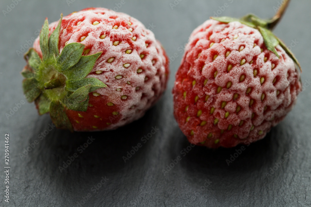 Close-up frozen strawberry covered by frost Close-up frozen strawberry covered by frost