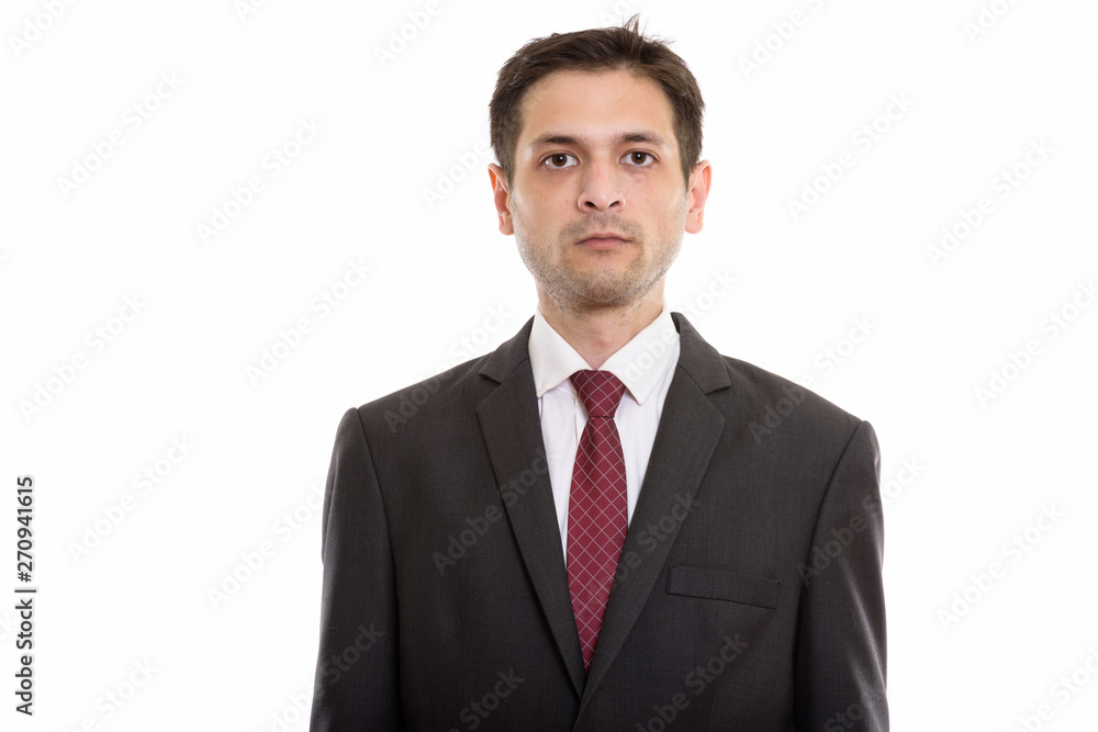 Studio shot of young businessman looking at camera Studio shot of young businessman looking at camera