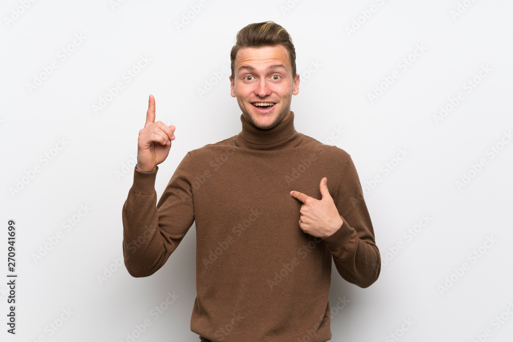Blonde man over isolated white wall with surprise and shocked facial expression Blonde man over isolated white wall with surprise and shocked facial expression