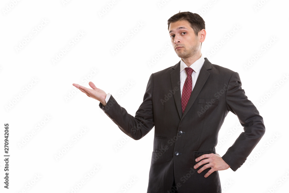 Studio shot of young businessman showing something Studio shot of young businessman showing something
