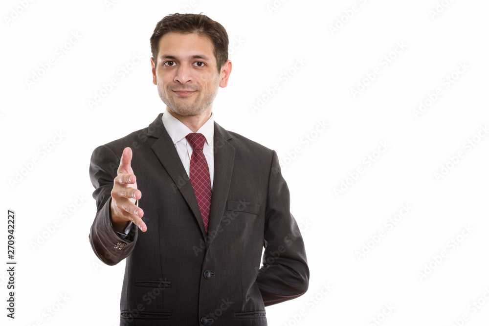 Studio shot of young businessman giving handshake Studio shot of young businessman giving handshake